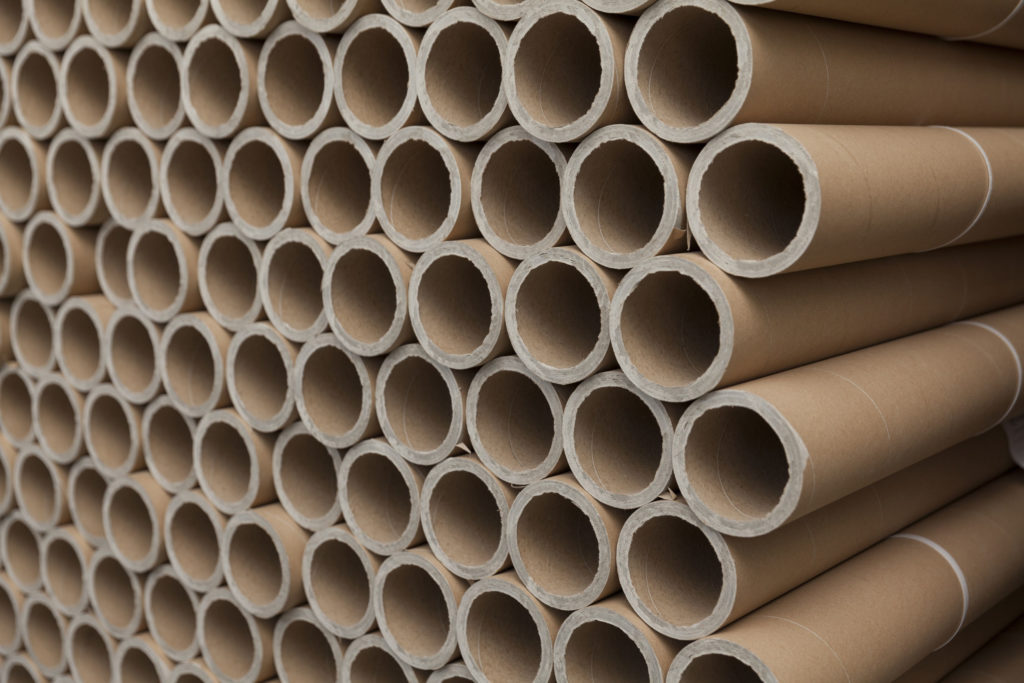 Large stack of cardboard tubes on top of eachother