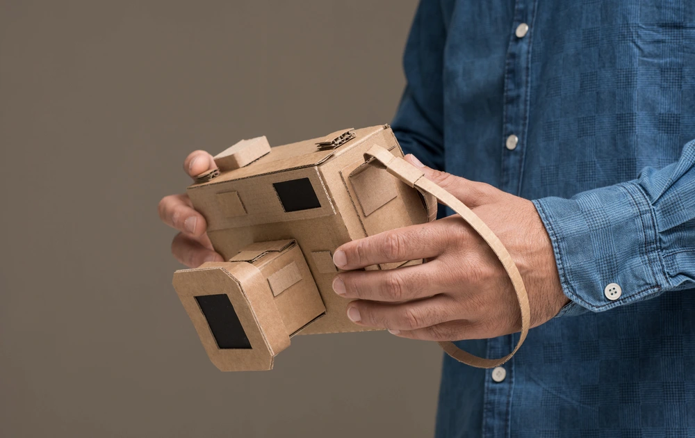 camera made out of cardboard being held