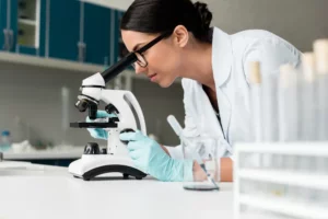woman scientist looking into a microscope