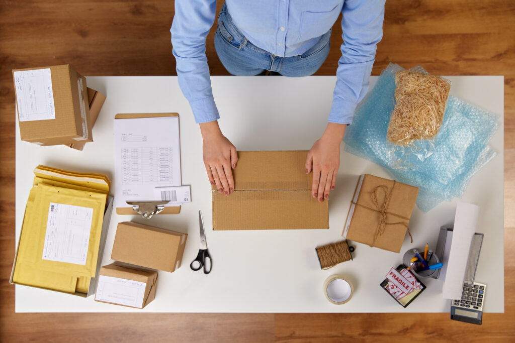 Man at a desk with packaging supplies