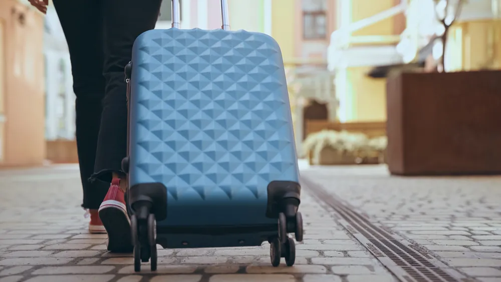 Blue Suitcase Carrying Cardboard Tubes