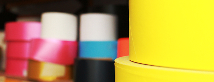 Coloured rolls of cardboard tubes stacked on each other