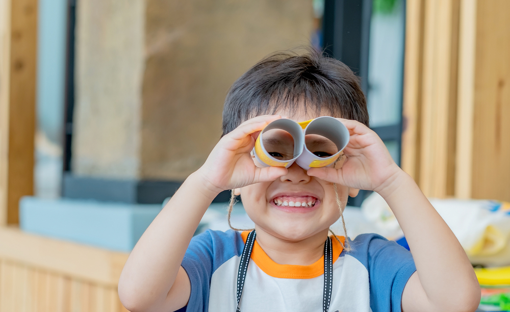 Kid using cardboard binoculars