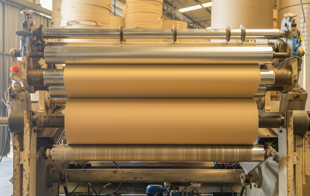 cardboard tubes being made in metal machine