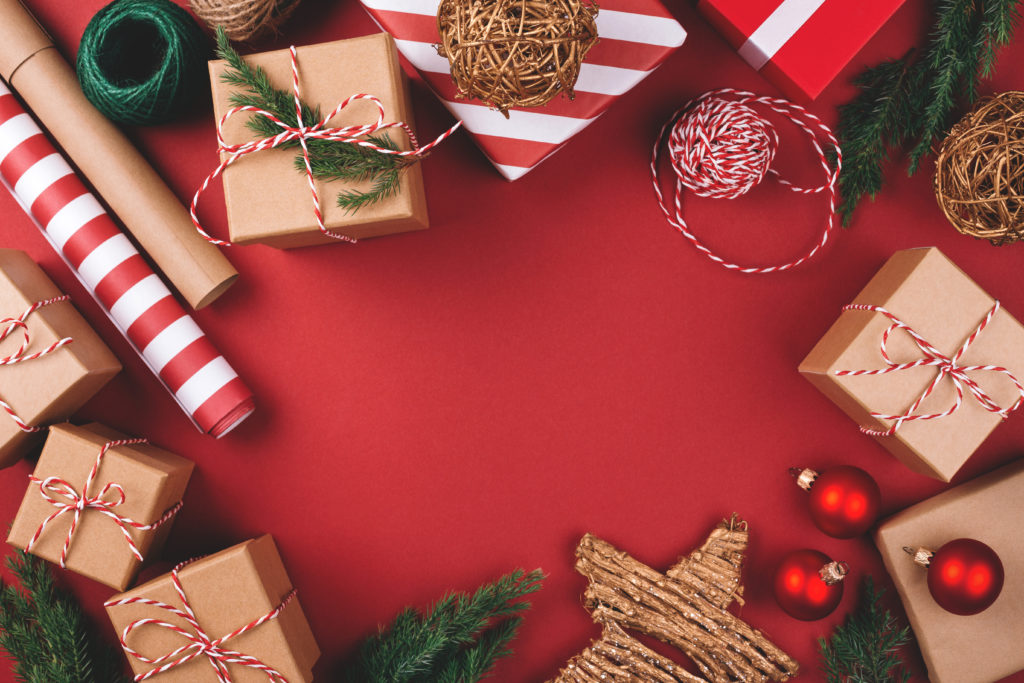 Christmas presents, wrapping paper, trees and decorations all scattered on the floor